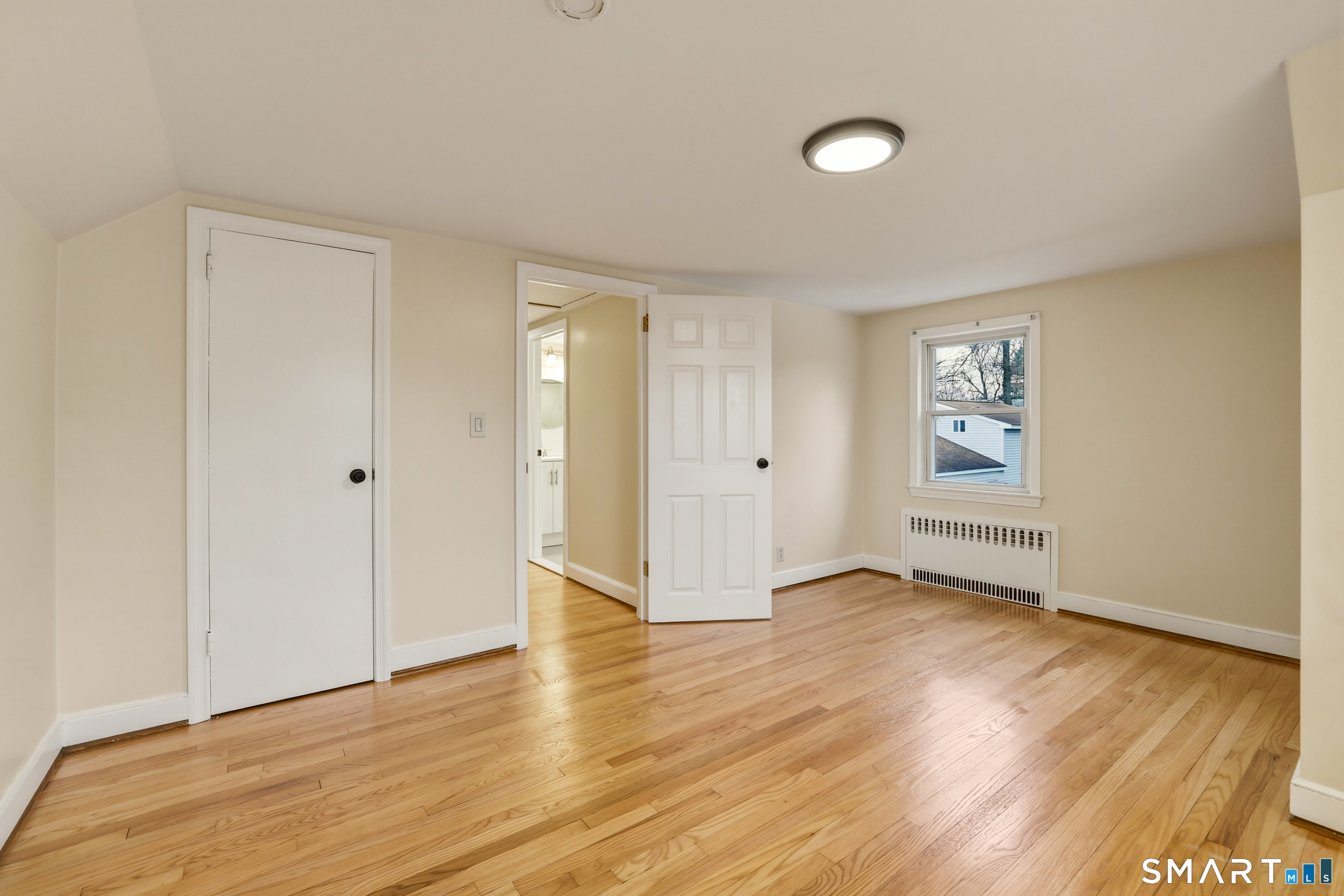 102 Lawler Road West Hartford, CT 06117 - Photo 28 of 42 an empty room with wooden floor and windows