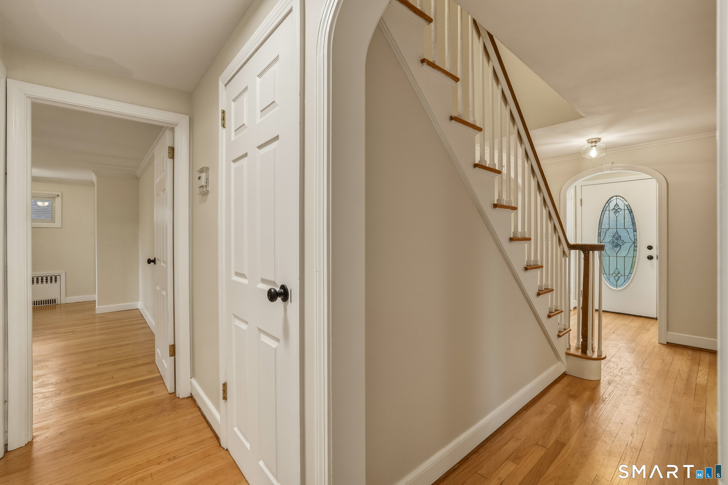102 Lawler Road West Hartford, CT 06117 - Photo 8 of 42 a view of a hallway with wooden floor and staircase