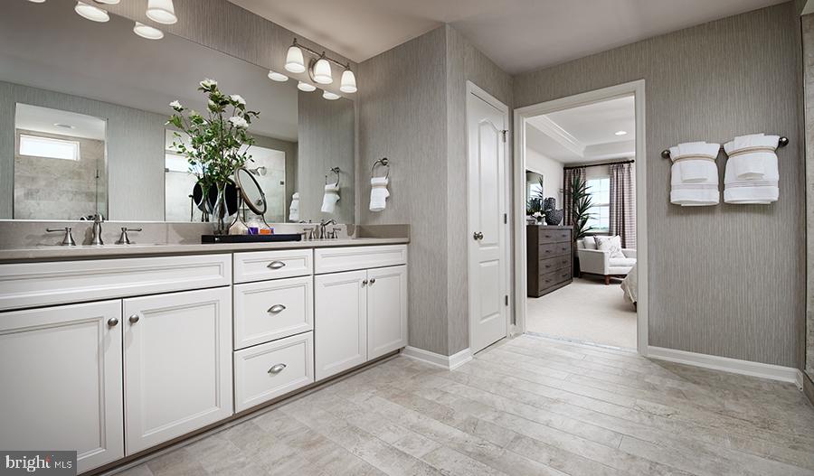 2064 Springvale Drive Bealeton, VA 22712 - Photo 2 of 10 a spacious en suite bathroom with a granite countertop sink a mirror and a shower