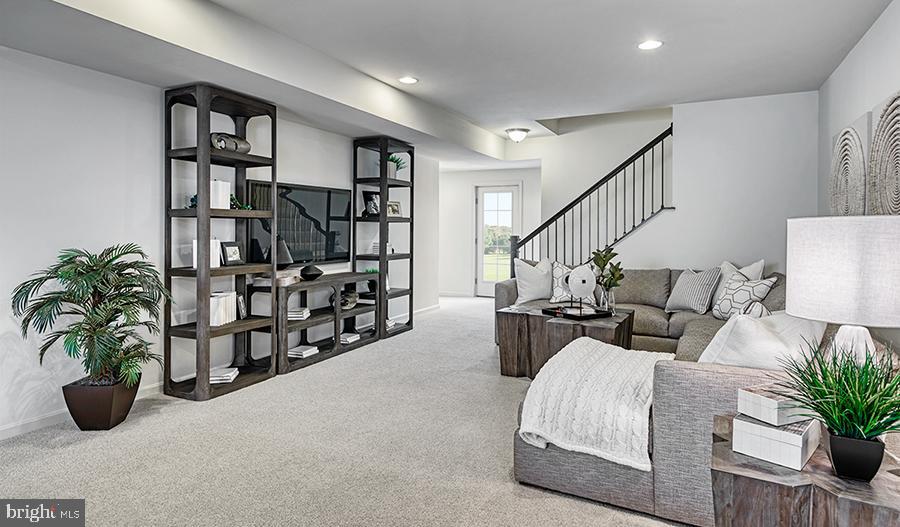2064 Springvale Drive Bealeton, VA 22712 - Photo 9 of 10 a living room with furniture potted plant and book shelf