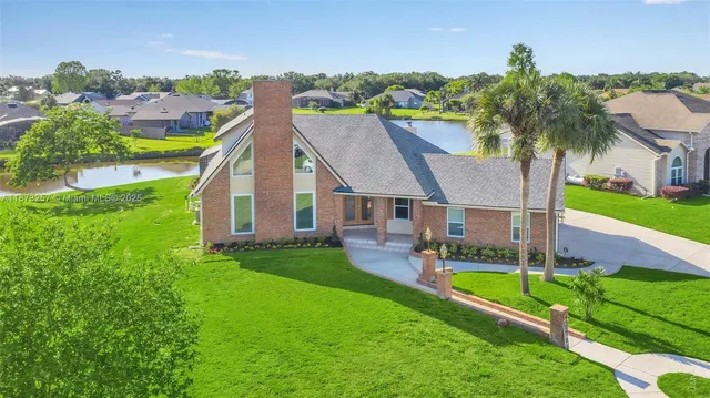 a aerial view of a house with swimming pool garden and patio