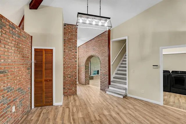 a view of a livingroom with wooden floor and staircase