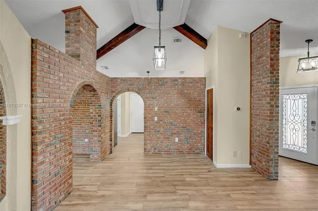 a view of empty room with wooden floor and ceiling fan