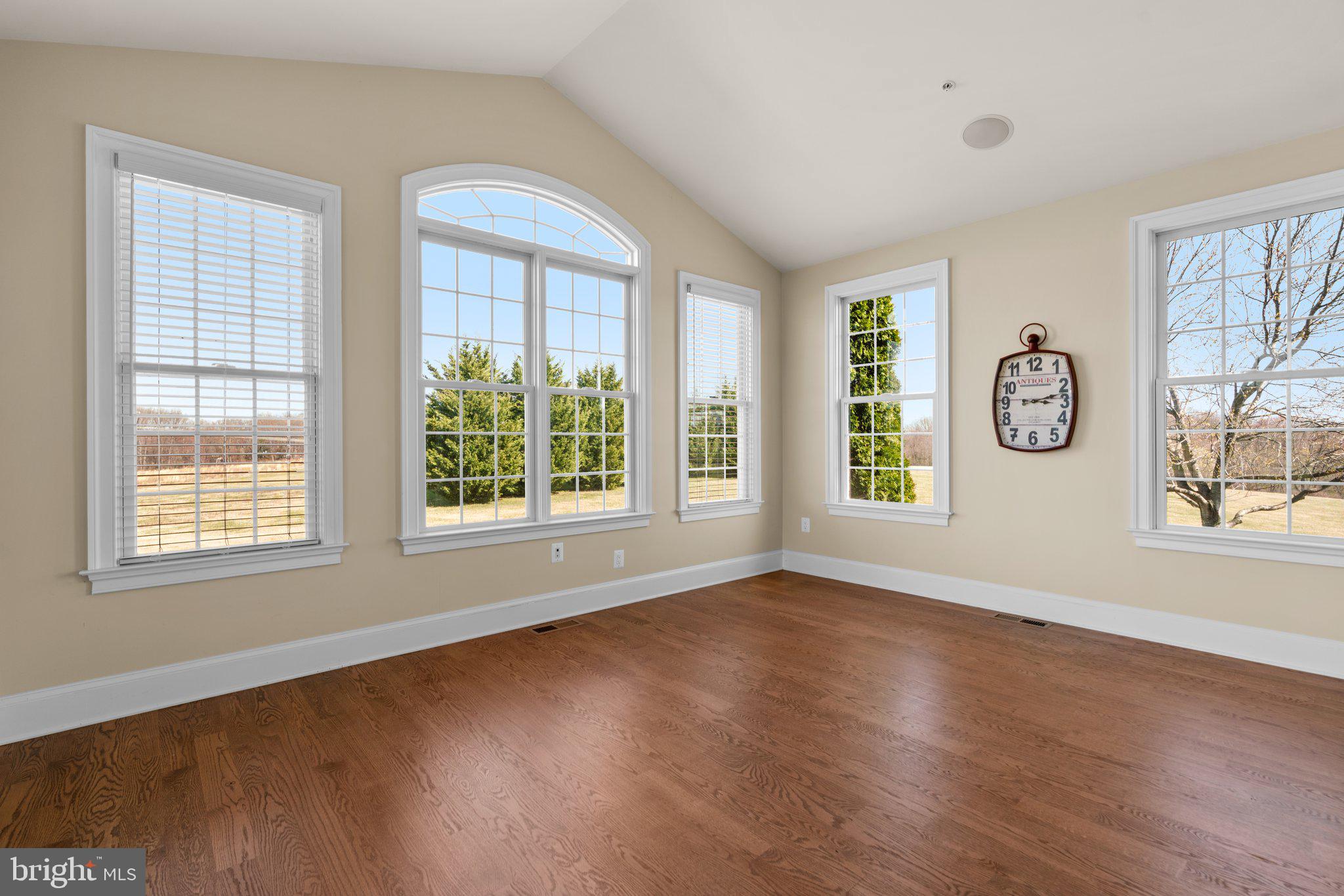 7251 Annapolis Rock Road Gaithersburg, MD 20882 - Photo 19 of 78 a view of an empty room with wooden floor and a window
