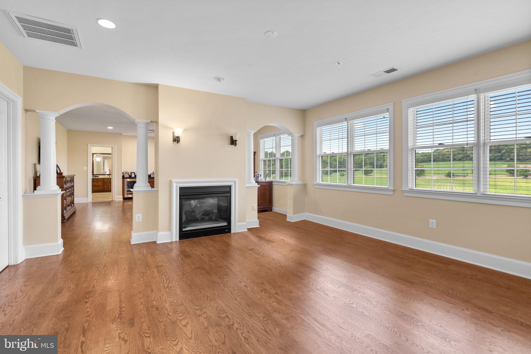 7251 Annapolis Rock Road Gaithersburg, MD 20882 - Photo 22 of 78 a view of a livingroom with a fireplace wooden floor and windows