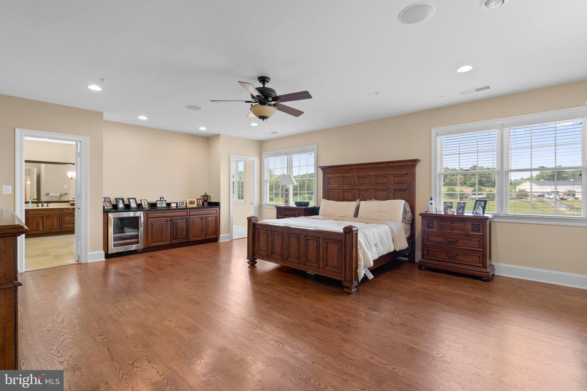 7251 Annapolis Rock Road Gaithersburg, MD 20882 - Photo 23 of 78 a spacious bedroom with a large bed and a chandelier