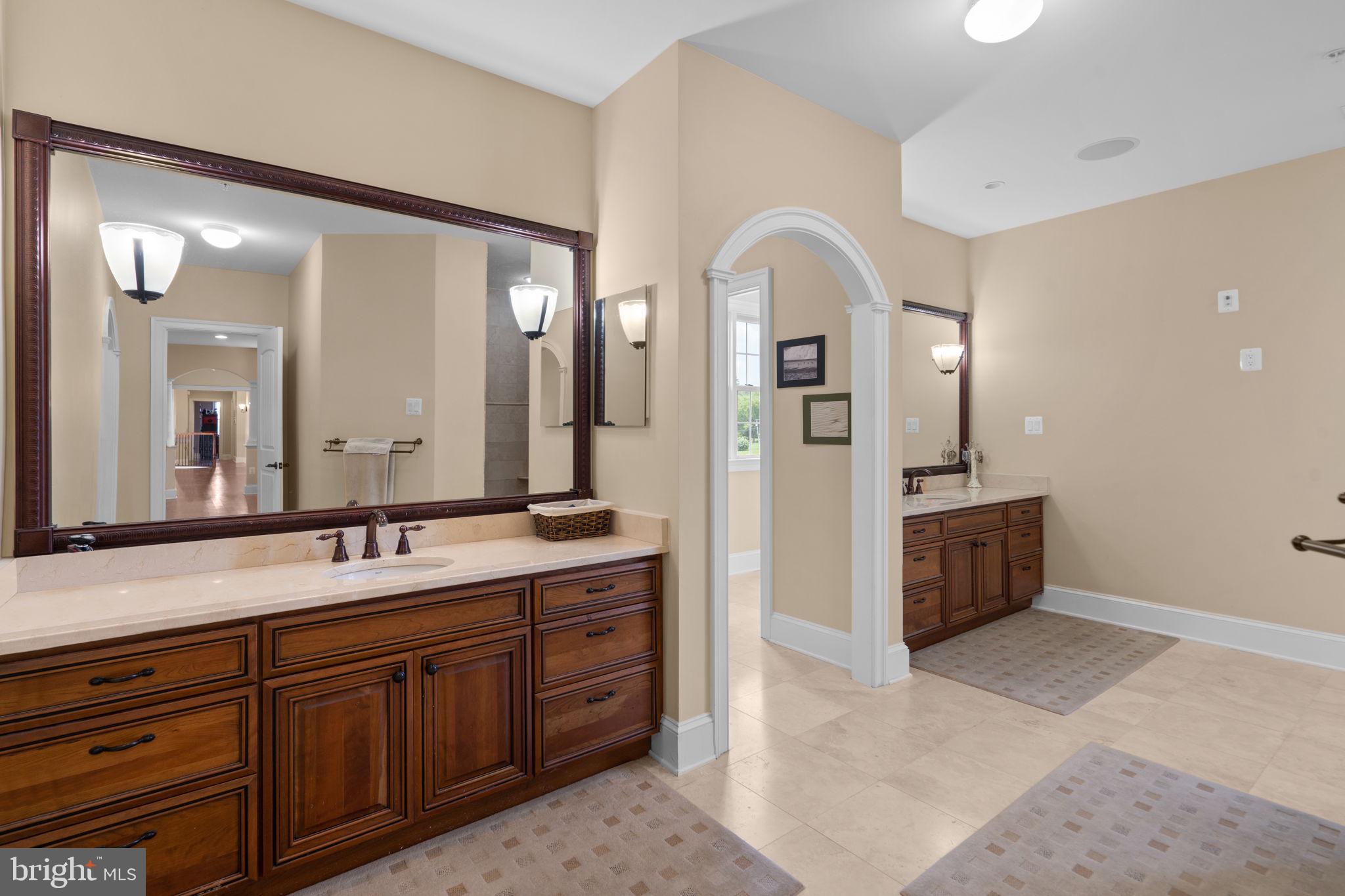 7251 Annapolis Rock Road Gaithersburg, MD 20882 - Photo 27 of 78 a spacious bathroom with a granite countertop sink mirror and bathtub