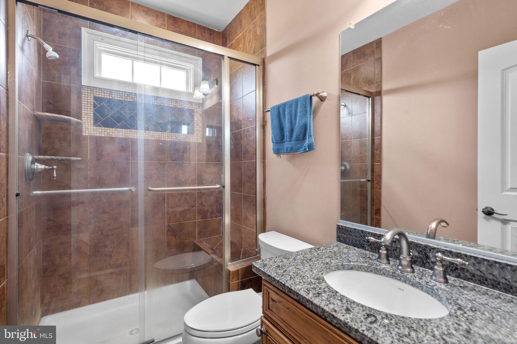 7251 Annapolis Rock Road Gaithersburg, MD 20882 - Photo 37 of 78 a bathroom with a granite countertop sink toilet and shower