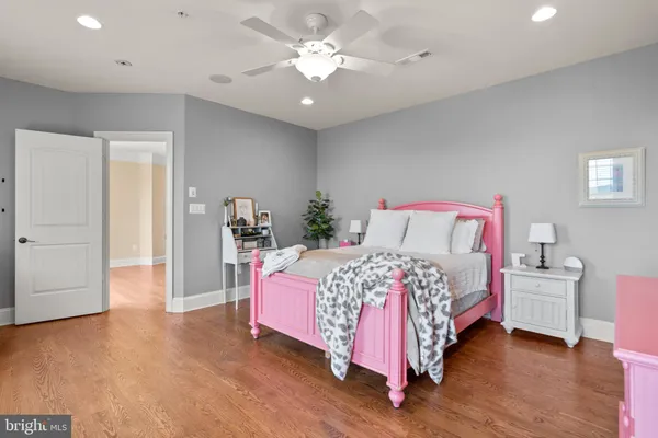 a kitchen with stainless steel appliances granite countertop a sink a stove and a wooden floors