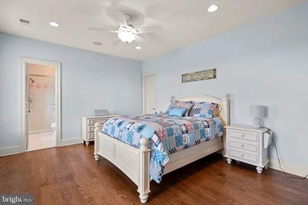 a bed room with a bed and a ceiling fan