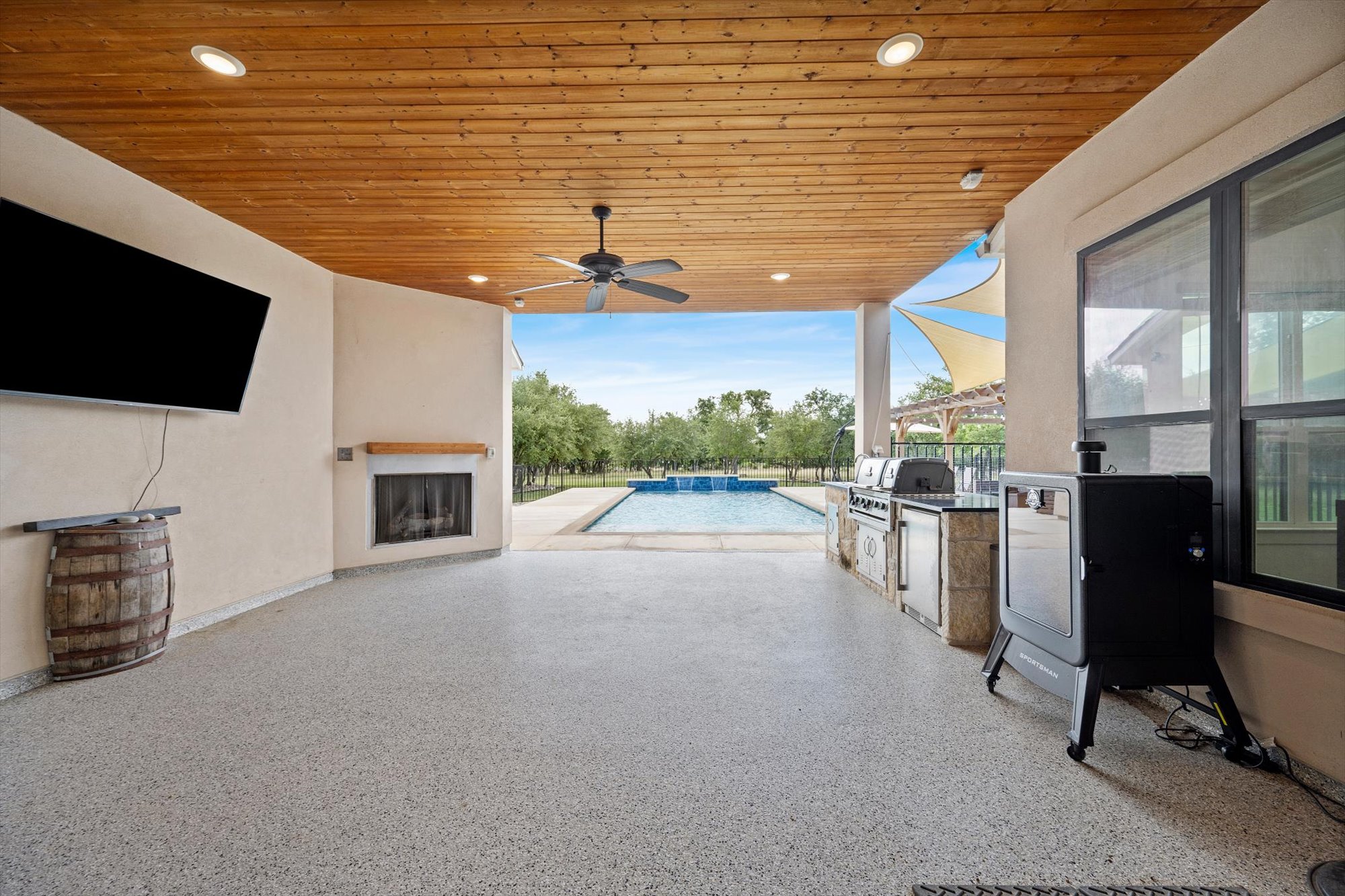 638 Strada Luca Florence, TX 76527 - Photo 32 of 38 An inviting outdoor living space features a cozy fireplace and a fully-equipped outdoor kitchen, all overlooking a refreshing pool.