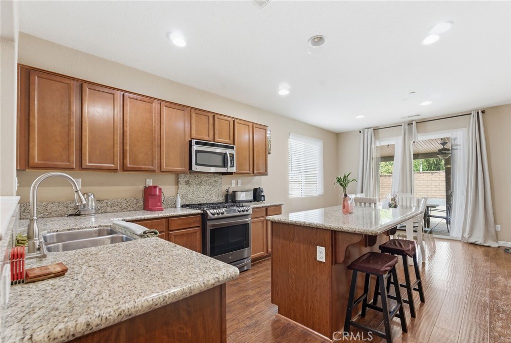 32634 Ritchart Court Temecula, CA 92592 - Photo 7 of 22 a kitchen with stainless steel appliances granite countertop a sink stove and refrigerator