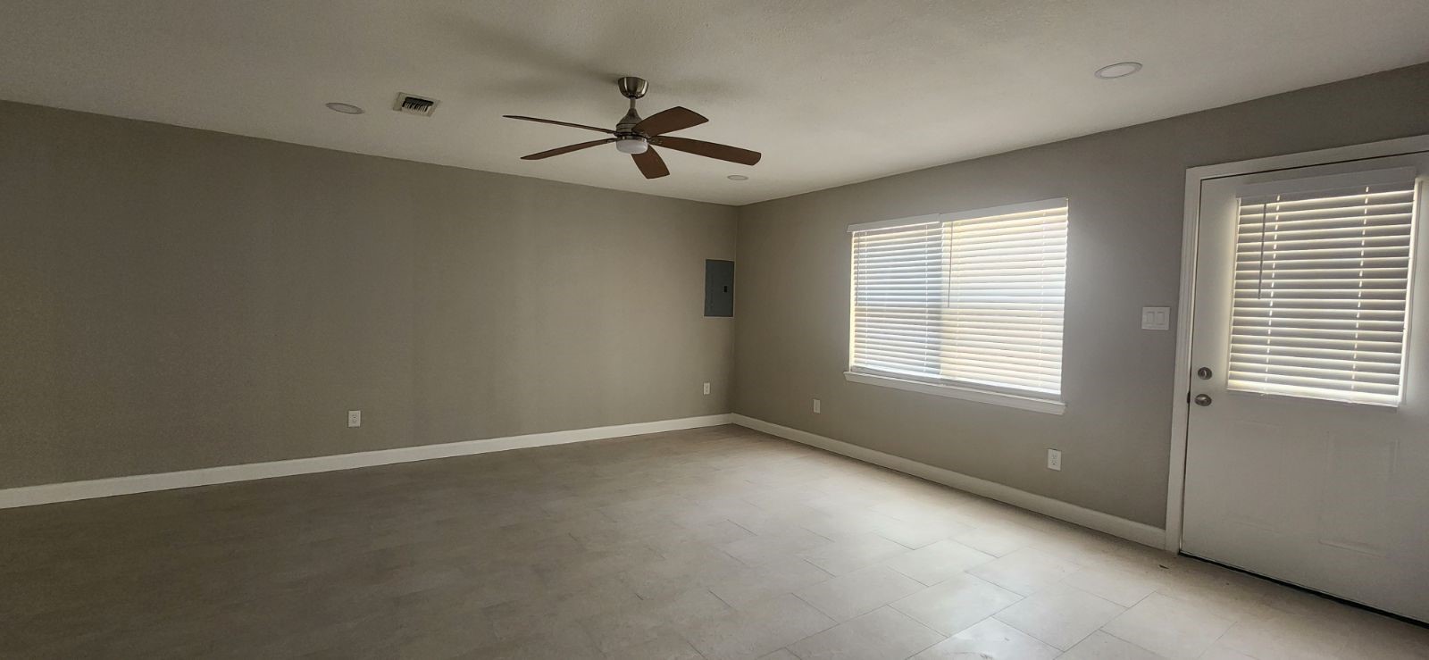 5006 Droddy Street Houston, TX 77091 - Photo 7 of 9 an empty room with a window and a fan
