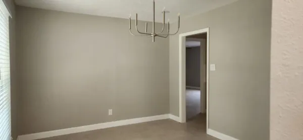 a view of a room with a empty space and a window