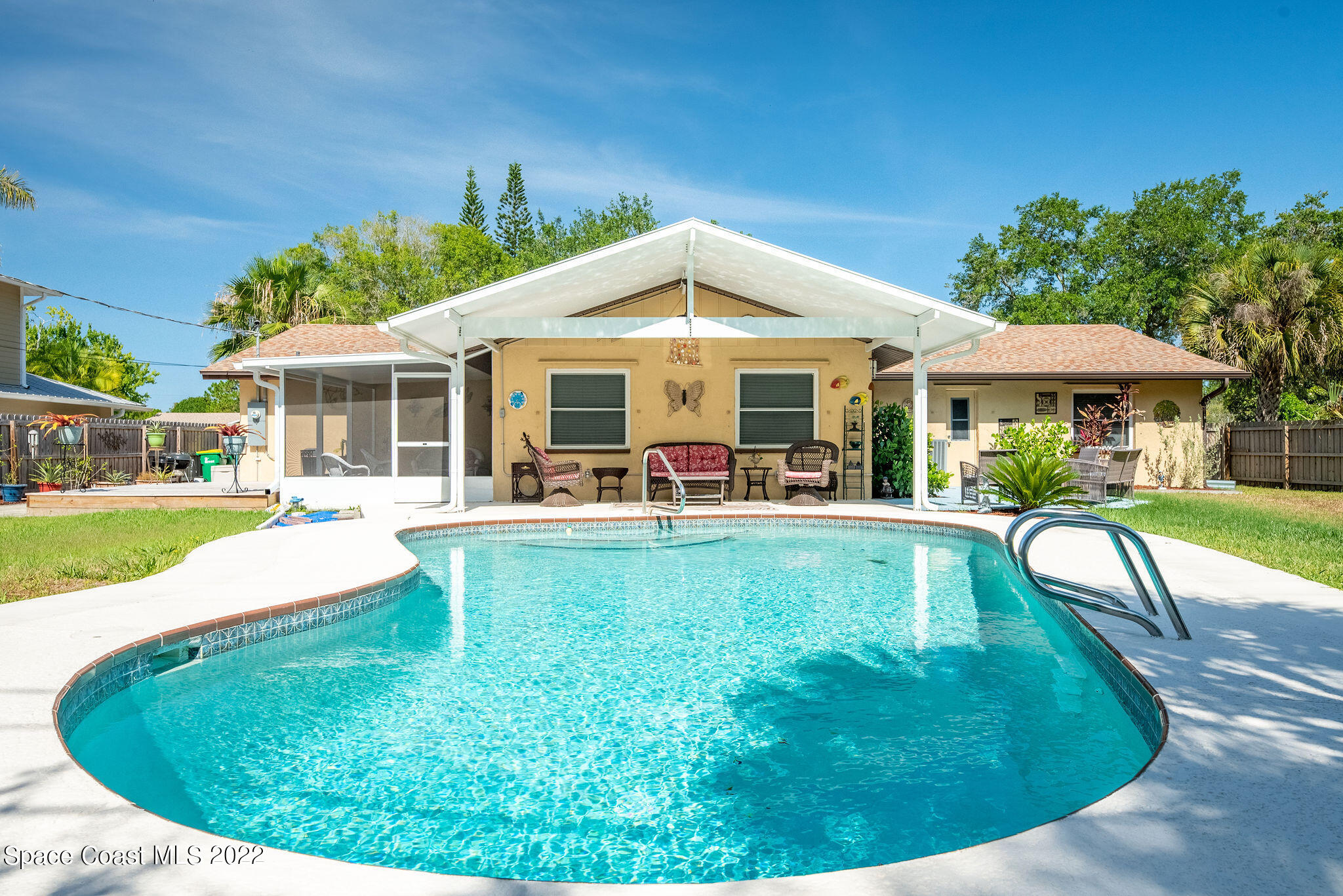 a view of a house with swimming pool and porch