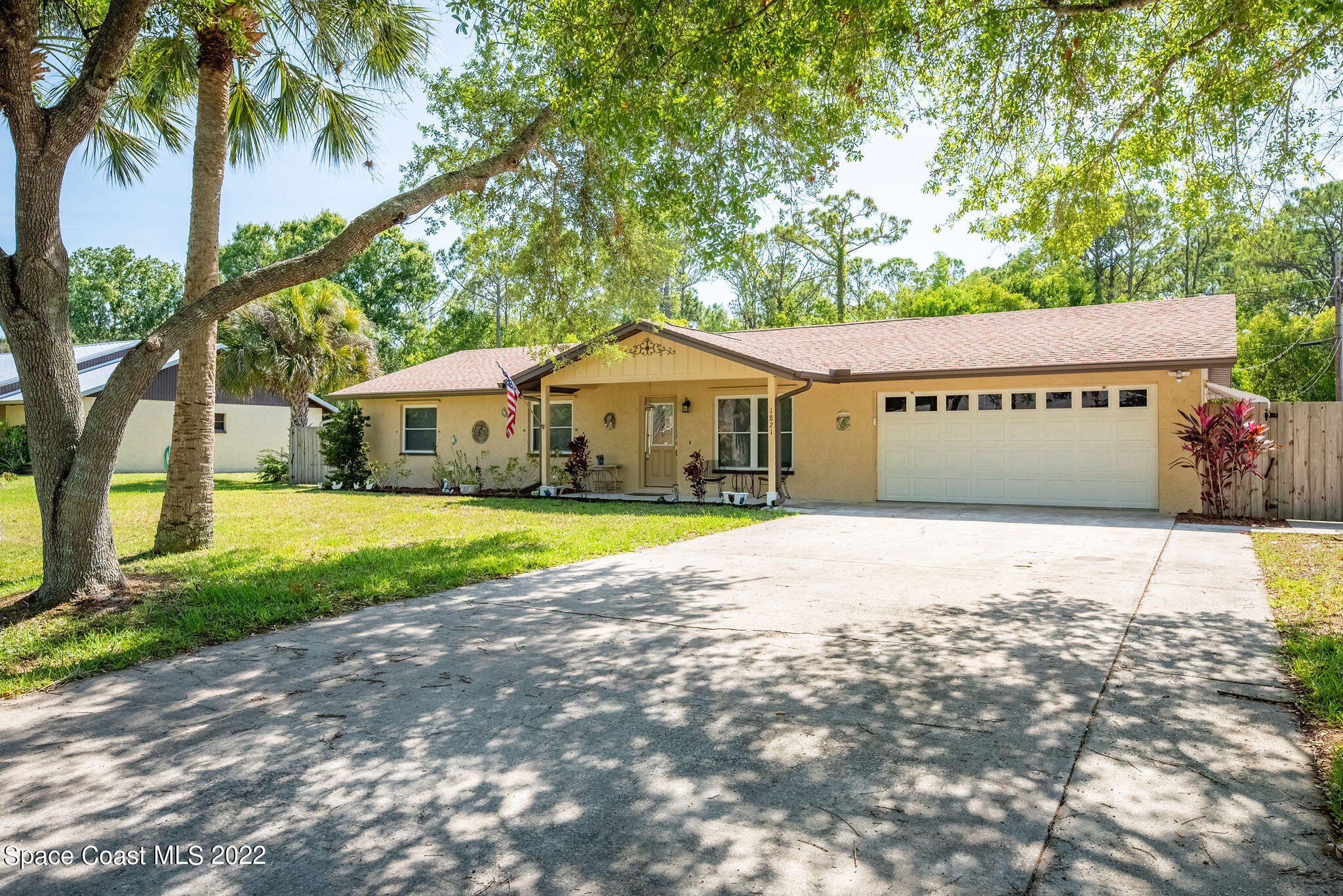 1821 Britt Road Cocoa, FL 32926 - Photo 2 of 63 a house with palm tree in front of it