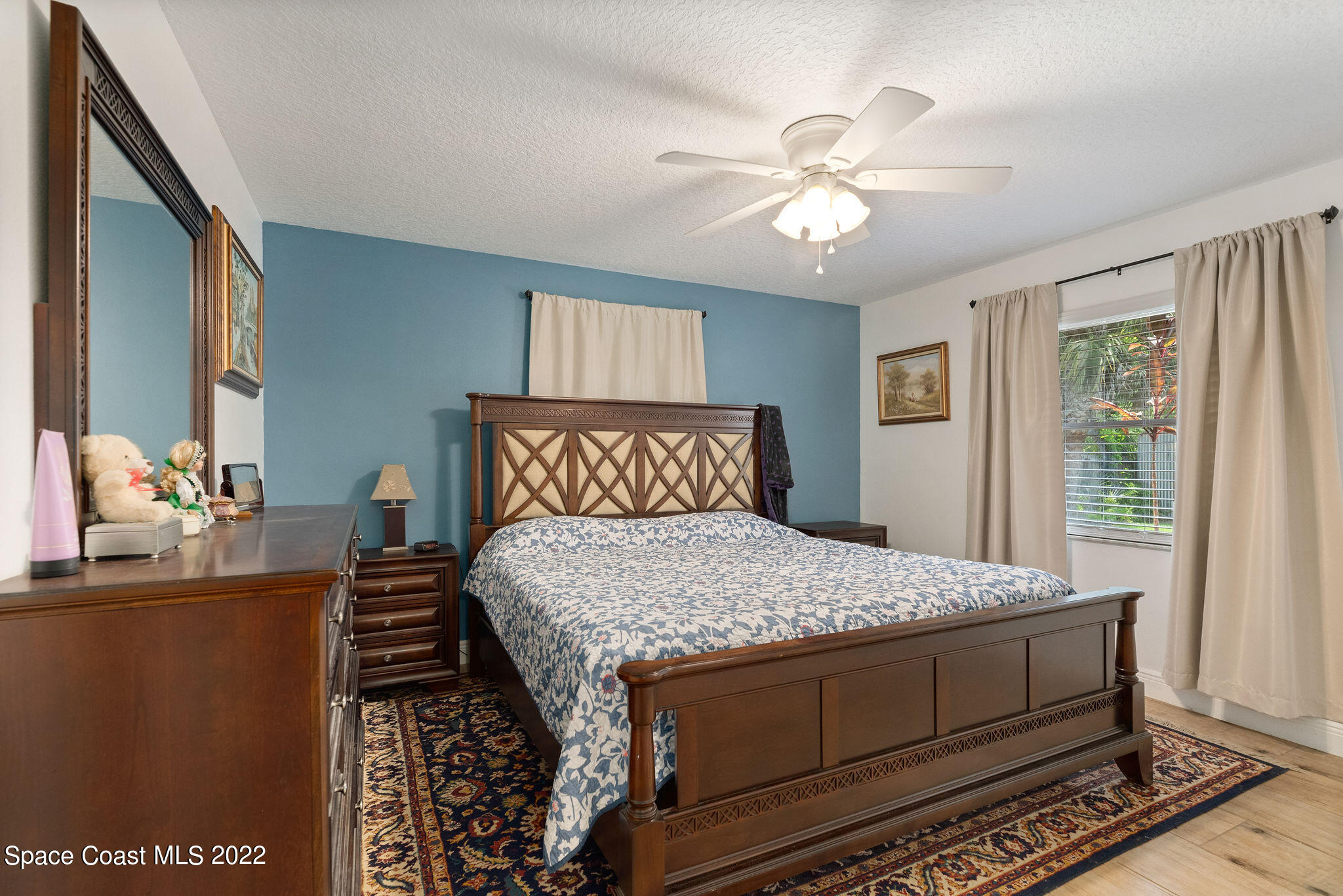 1821 Britt Road Cocoa, FL 32926 - Photo 27 of 63 a bedroom with a bed and a chandelier