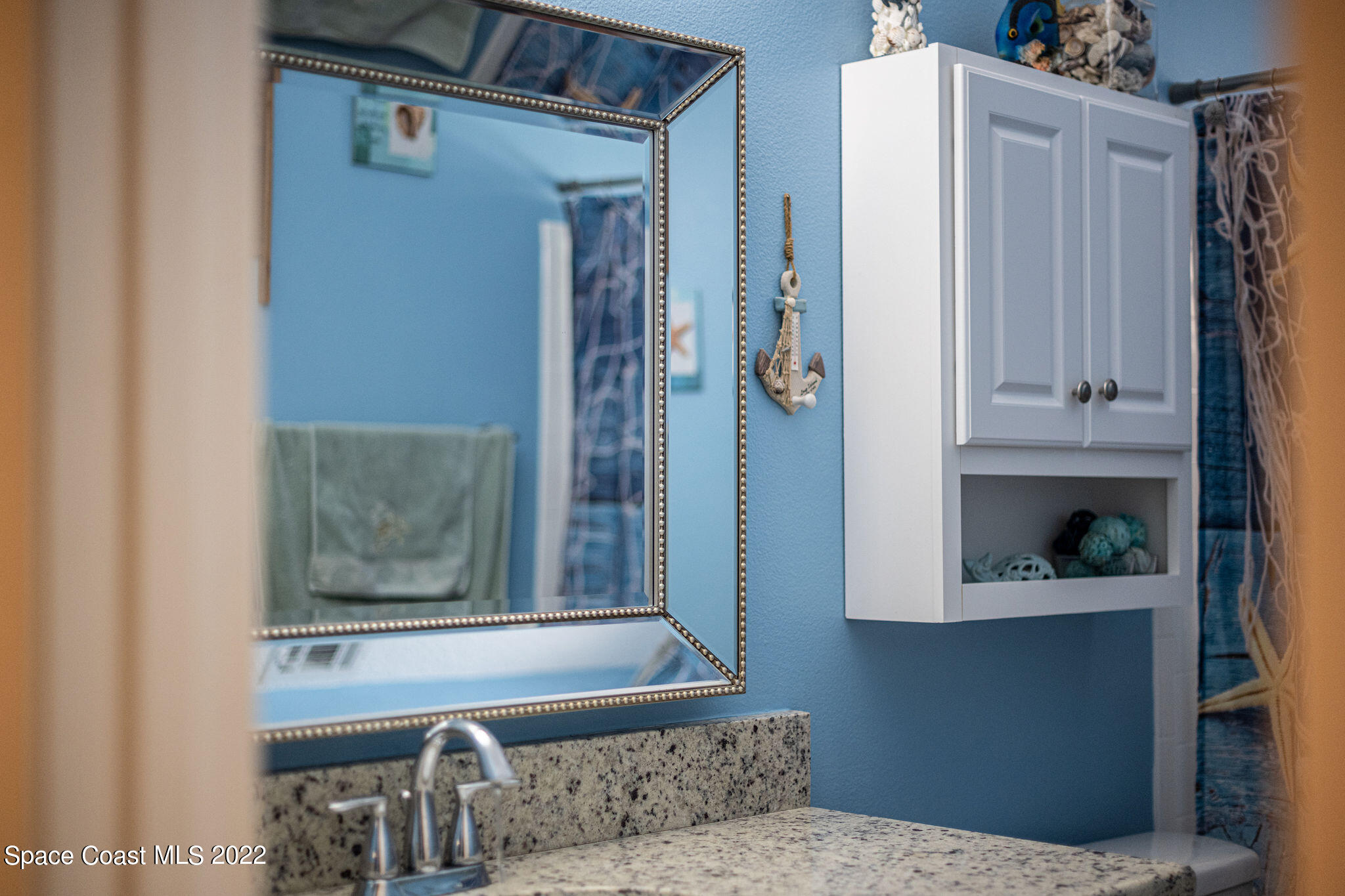 1821 Britt Road Cocoa, FL 32926 - Photo 30 of 63 a living room with a bed and cabinets