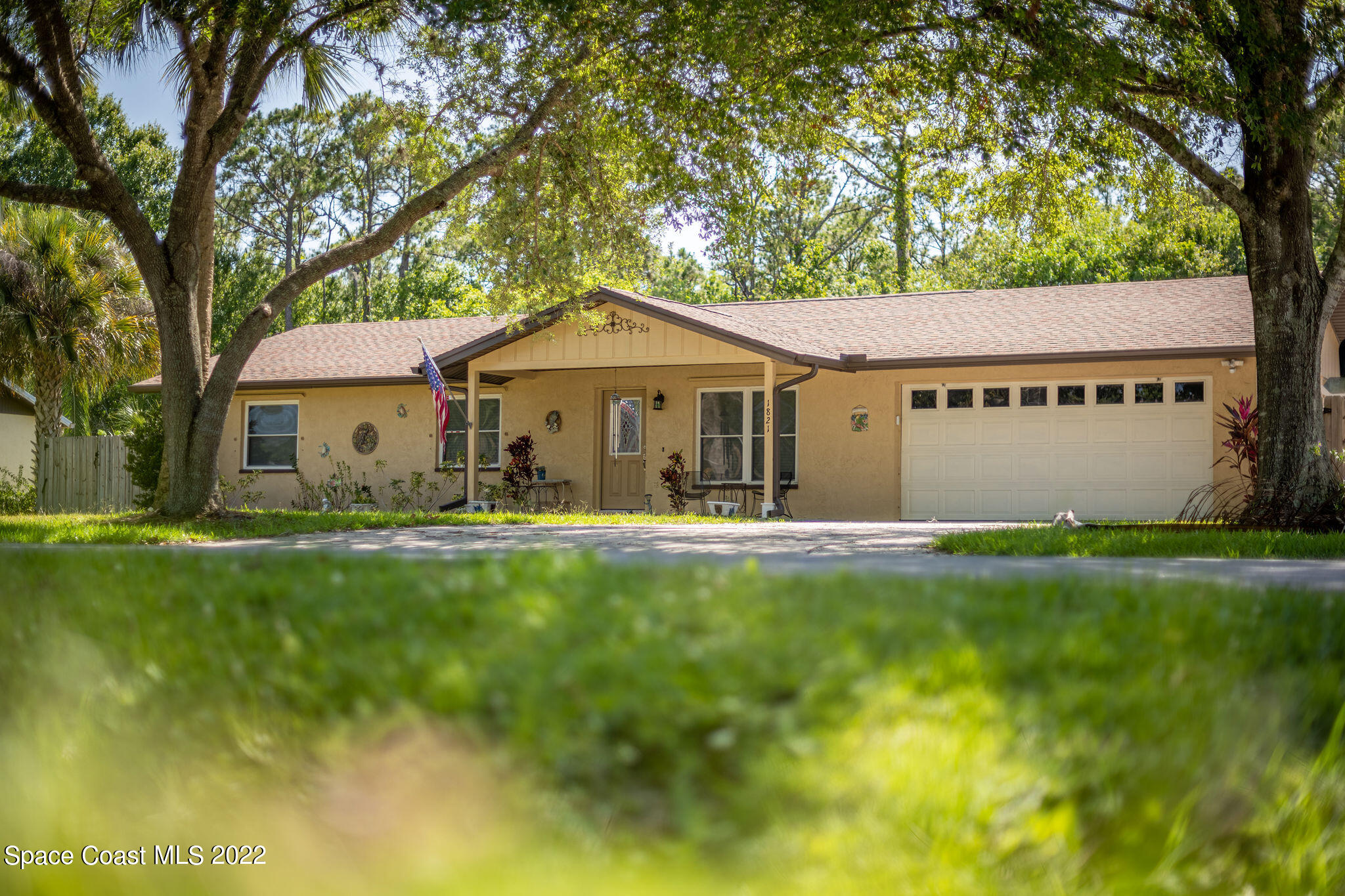 1821 Britt Road Cocoa, FL 32926 - Photo 3 of 63 a front view of a house with a garden and deck
