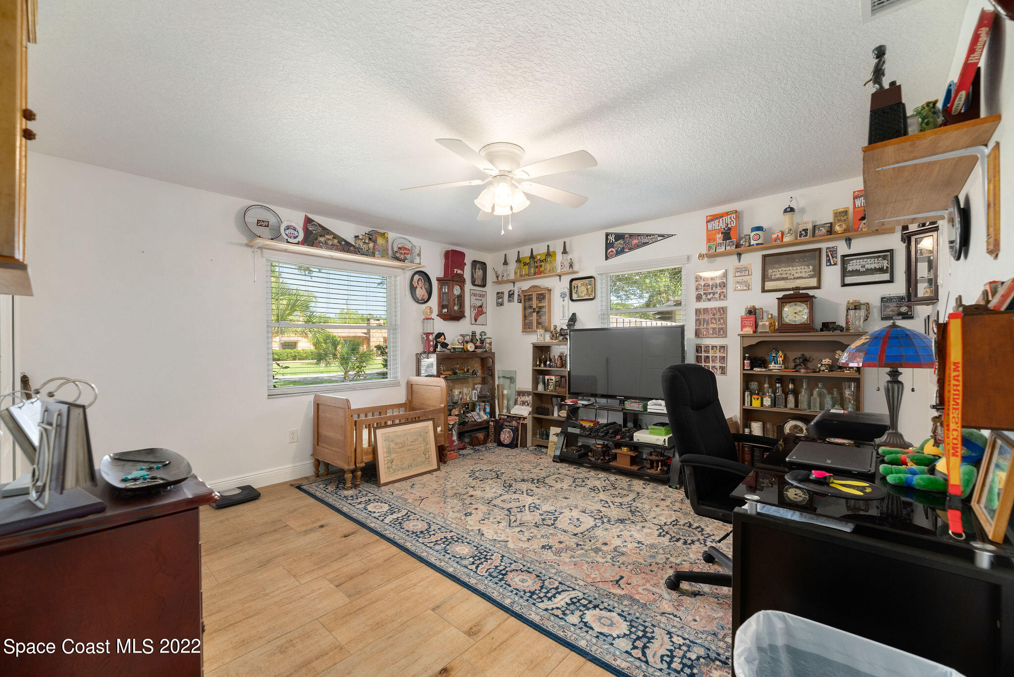 1821 Britt Road Cocoa, FL 32926 - Photo 31 of 63 a living room with lots of furniture and clutter