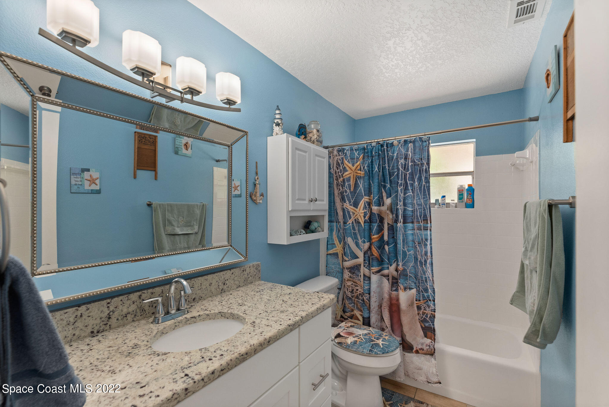 1821 Britt Road Cocoa, FL 32926 - Photo 32 of 63 a bathroom with a granite countertop sink toilet and shower