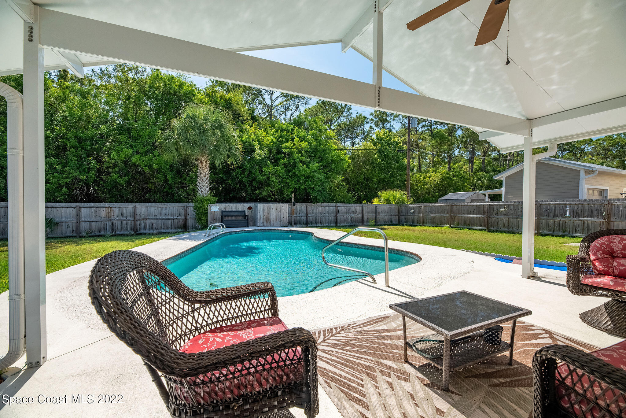 1821 Britt Road Cocoa, FL 32926 - Photo 45 of 63 a view of a patio with a table chairs and a swimming pool