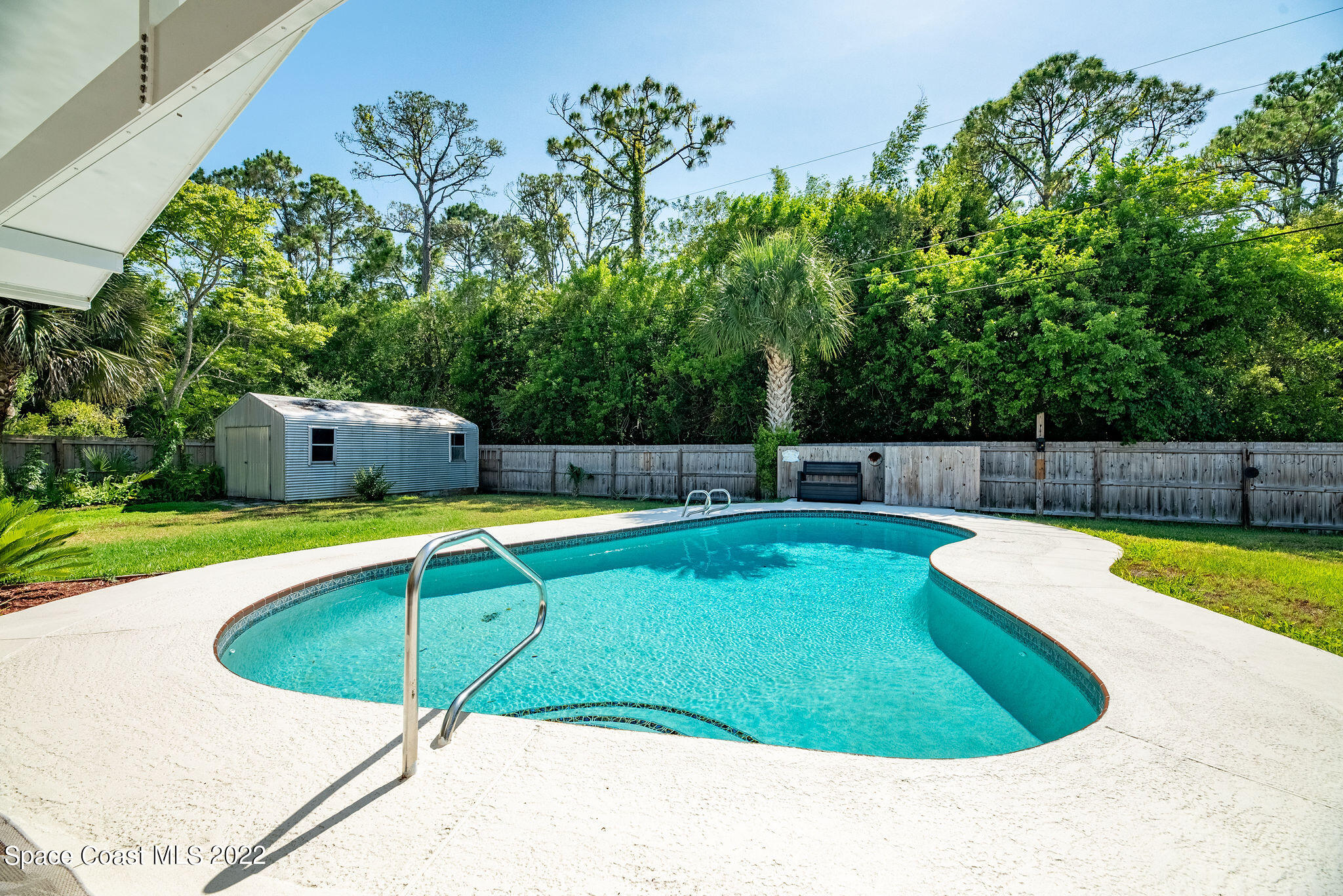 1821 Britt Road Cocoa, FL 32926 - Photo 50 of 63 a view of a swimming pool with a patio and yard