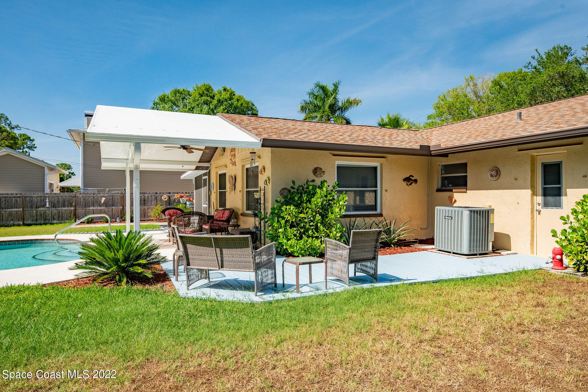 1821 Britt Road Cocoa, FL 32926 - Photo 54 of 63 a view of a patio with table and chairs potted plants and a large tree
