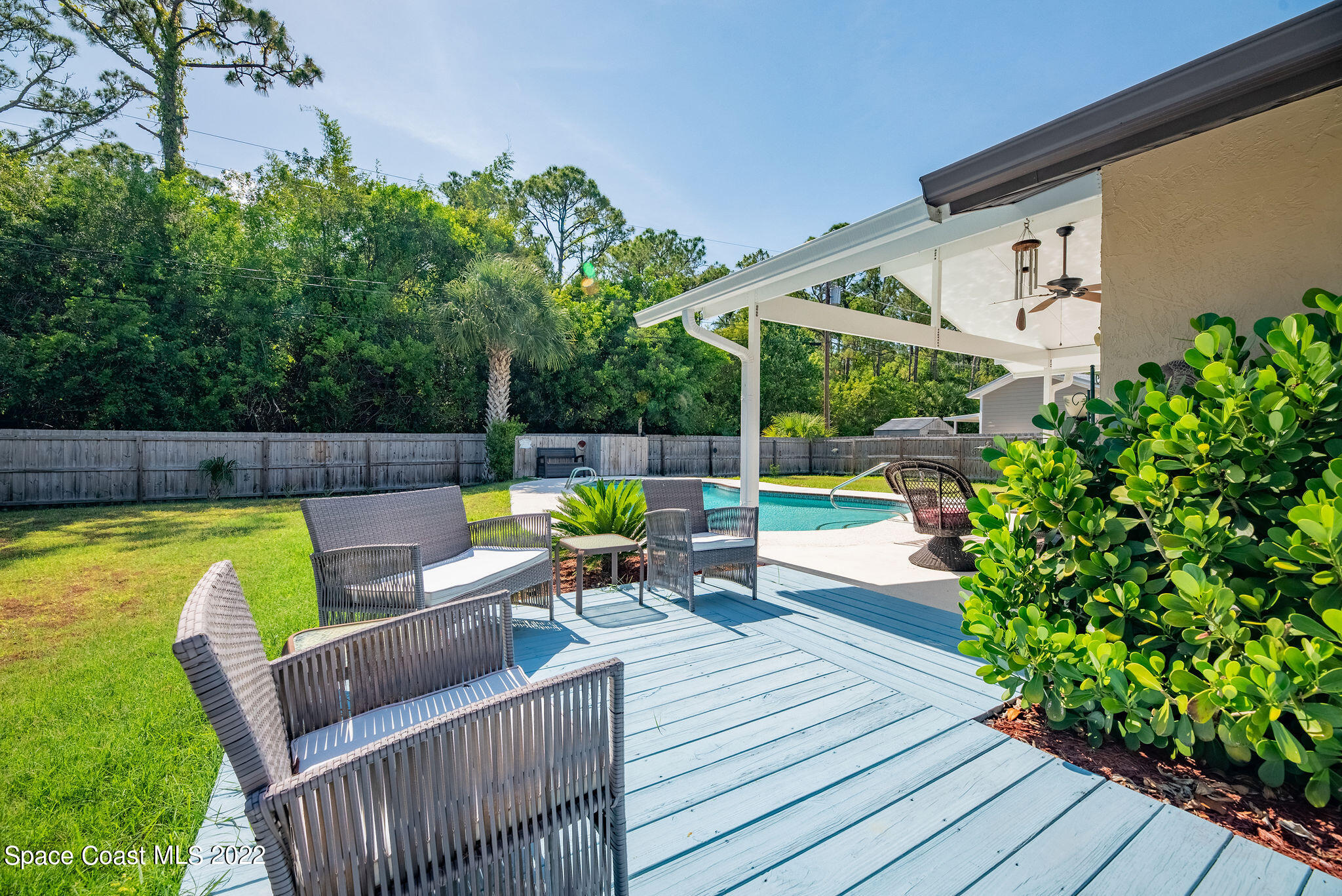 1821 Britt Road Cocoa, FL 32926 - Photo 56 of 63 a view of deck with table and chairs potted plants with wooden floor and fence