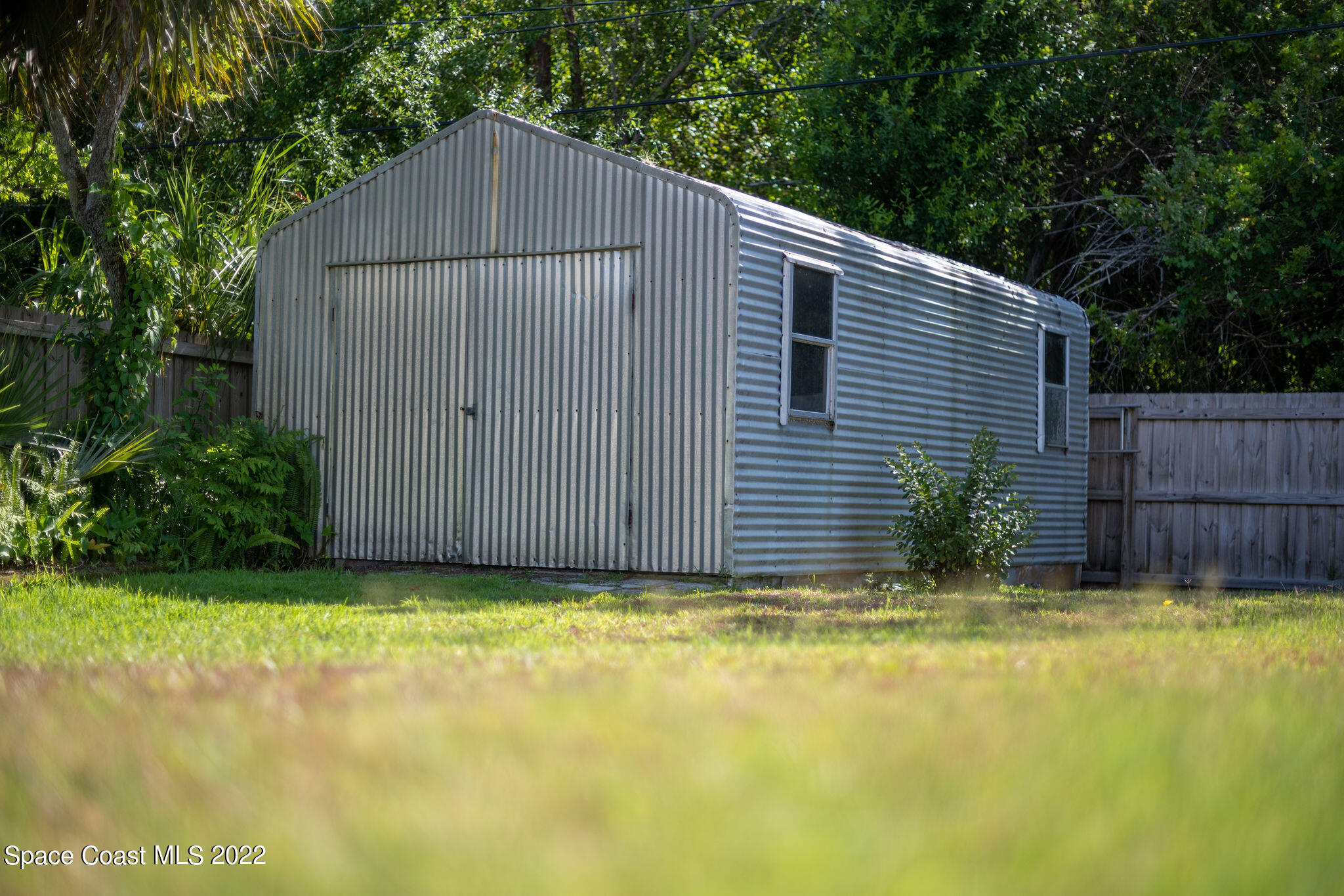 1821 Britt Road Cocoa, FL 32926 - Photo 61 of 63 a view of a backyard with a small cabin