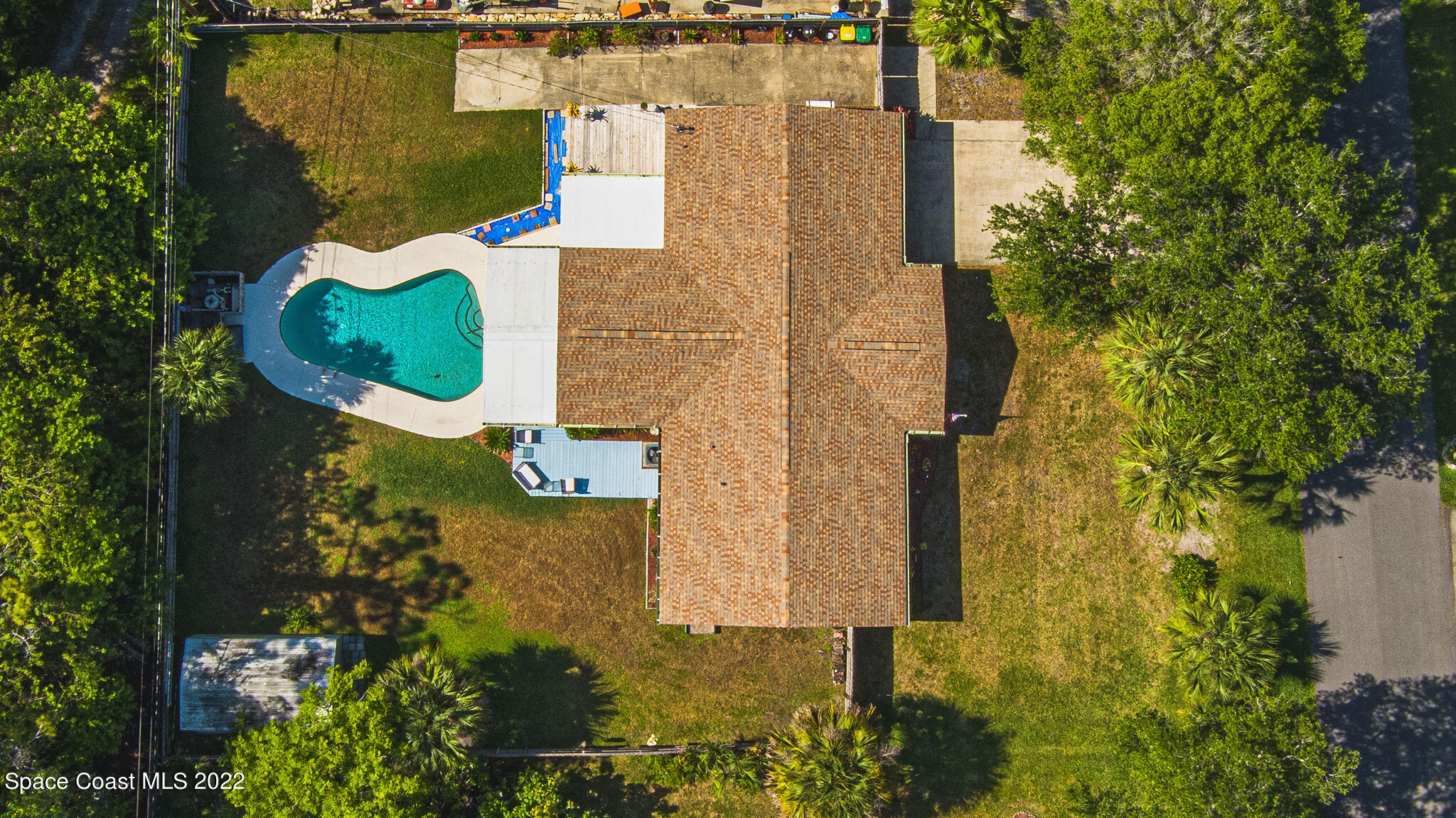 1821 Britt Road Cocoa, FL 32926 - Photo 9 of 63 aerial view of a house with a yard and large trees