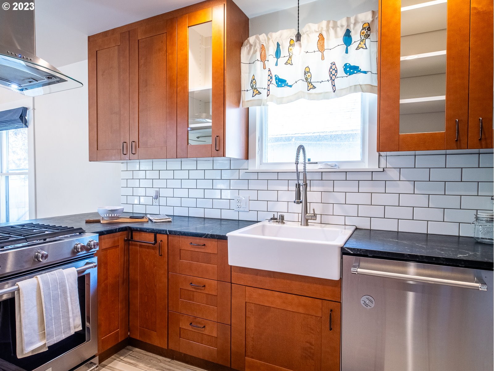 903 North Winchell Street Portland, OR 97217 - Photo 12 of 34 a kitchen with stainless steel appliances a sink window and cabinets