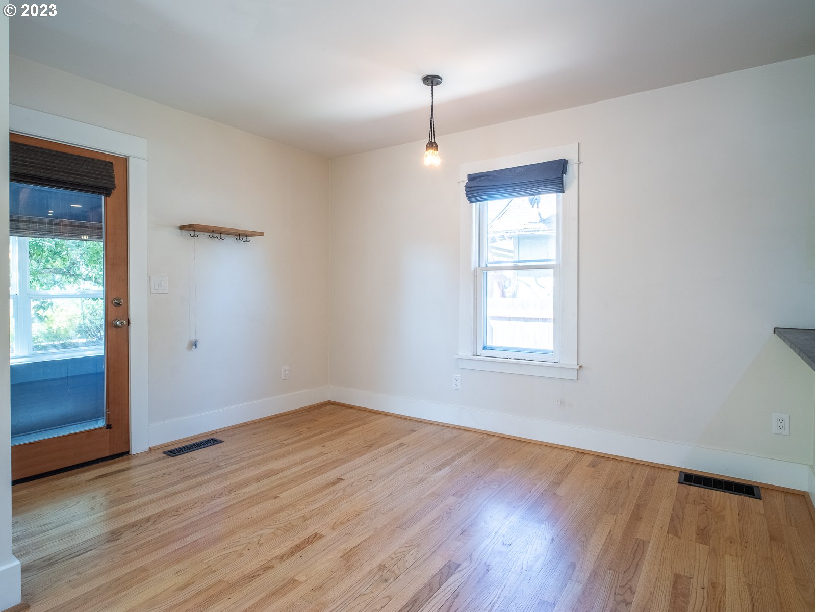 903 North Winchell Street Portland, OR 97217 - Photo 16 of 34 an empty room with wooden floor cabinet and windows