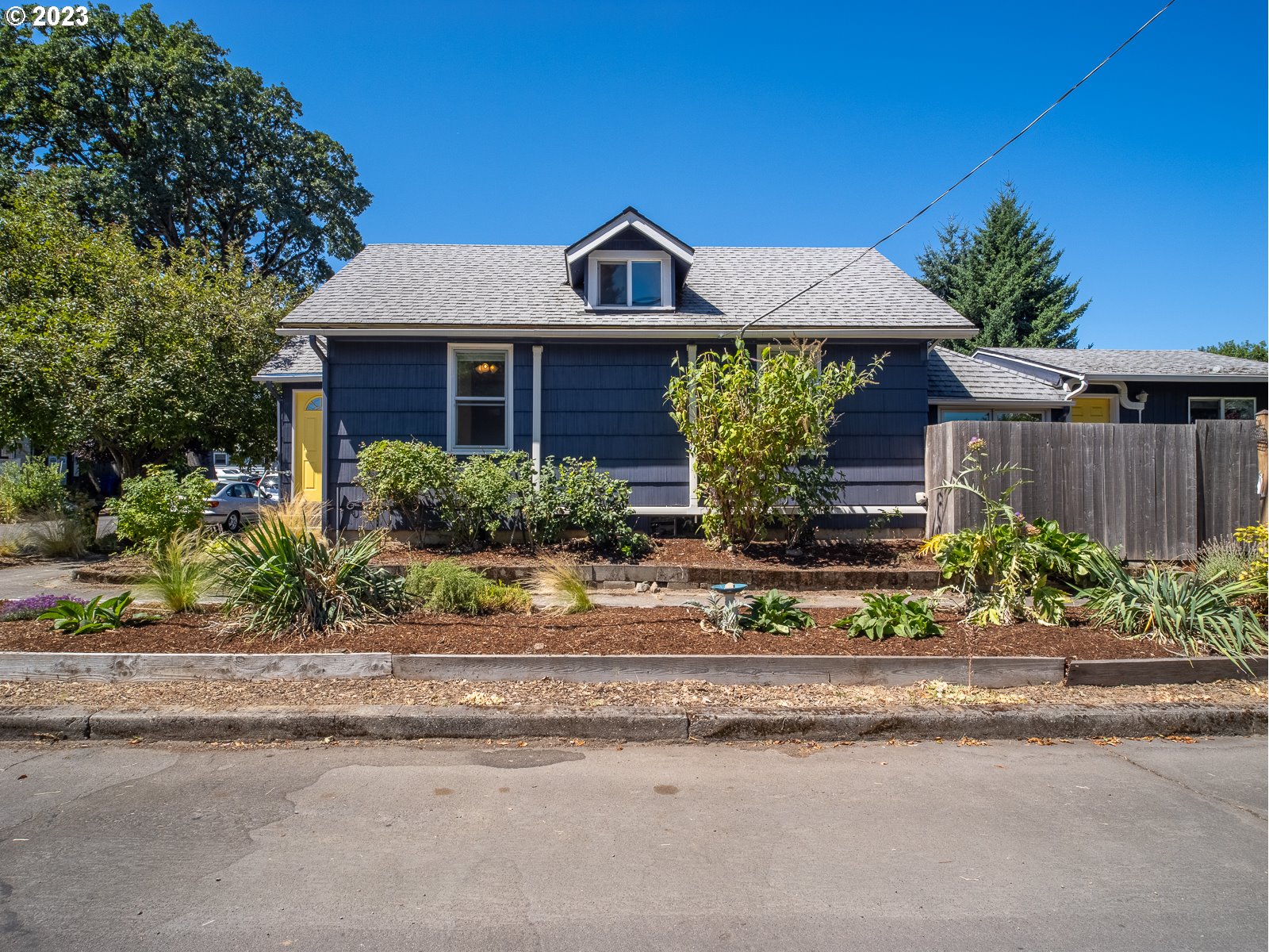 903 North Winchell Street Portland, OR 97217 - Photo 3 of 34 a front view of a house with a yard and potted plants