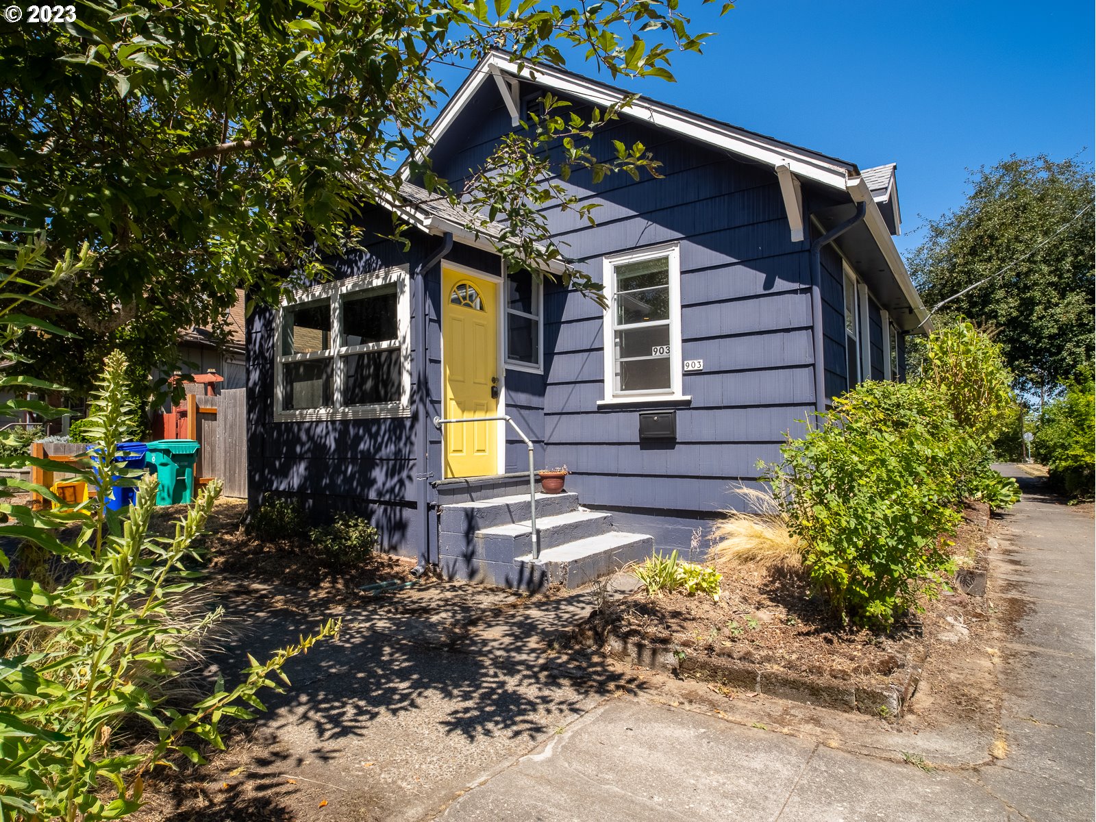 903 North Winchell Street Portland, OR 97217 - Photo 5 of 34 a view of a house with a small yard and plants