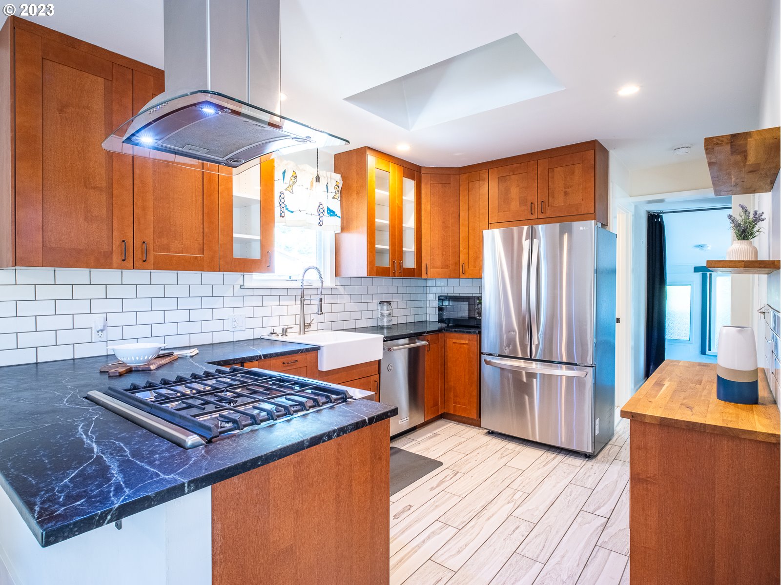 903 North Winchell Street Portland, OR 97217 - Photo 10 of 34 a kitchen with stainless steel appliances granite countertop a refrigerator and a stove top oven