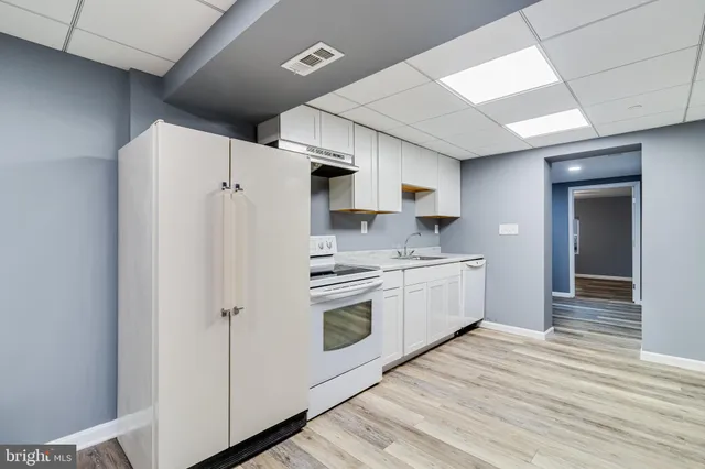 a kitchen with stainless steel appliances a refrigerator sink and cabinets