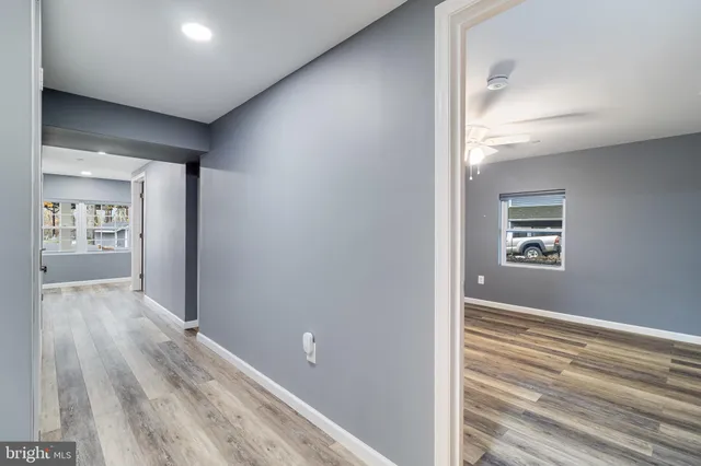 a view of hallway with wooden floor