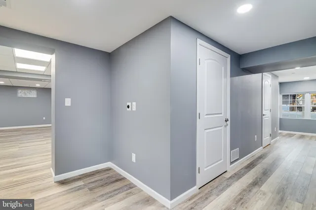 a view of hallway with wooden floor