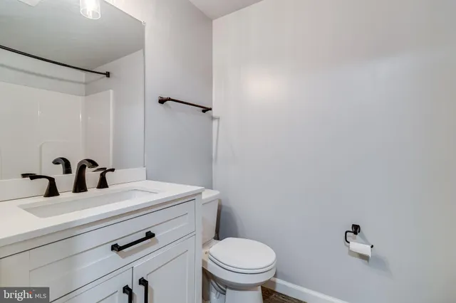 a bathroom with a sink a toilet and mirror