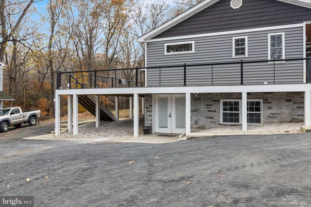a view of a house with a large window and brick wall