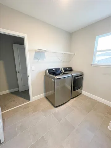 a swimming pool with an outdoor seating and a garden