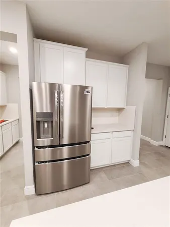 a refrigerator freezer sitting in a kitchen