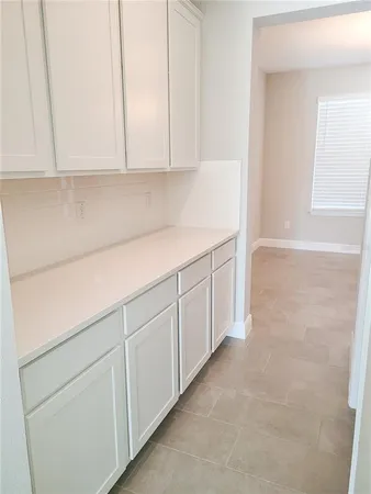 a kitchen with white cabinets