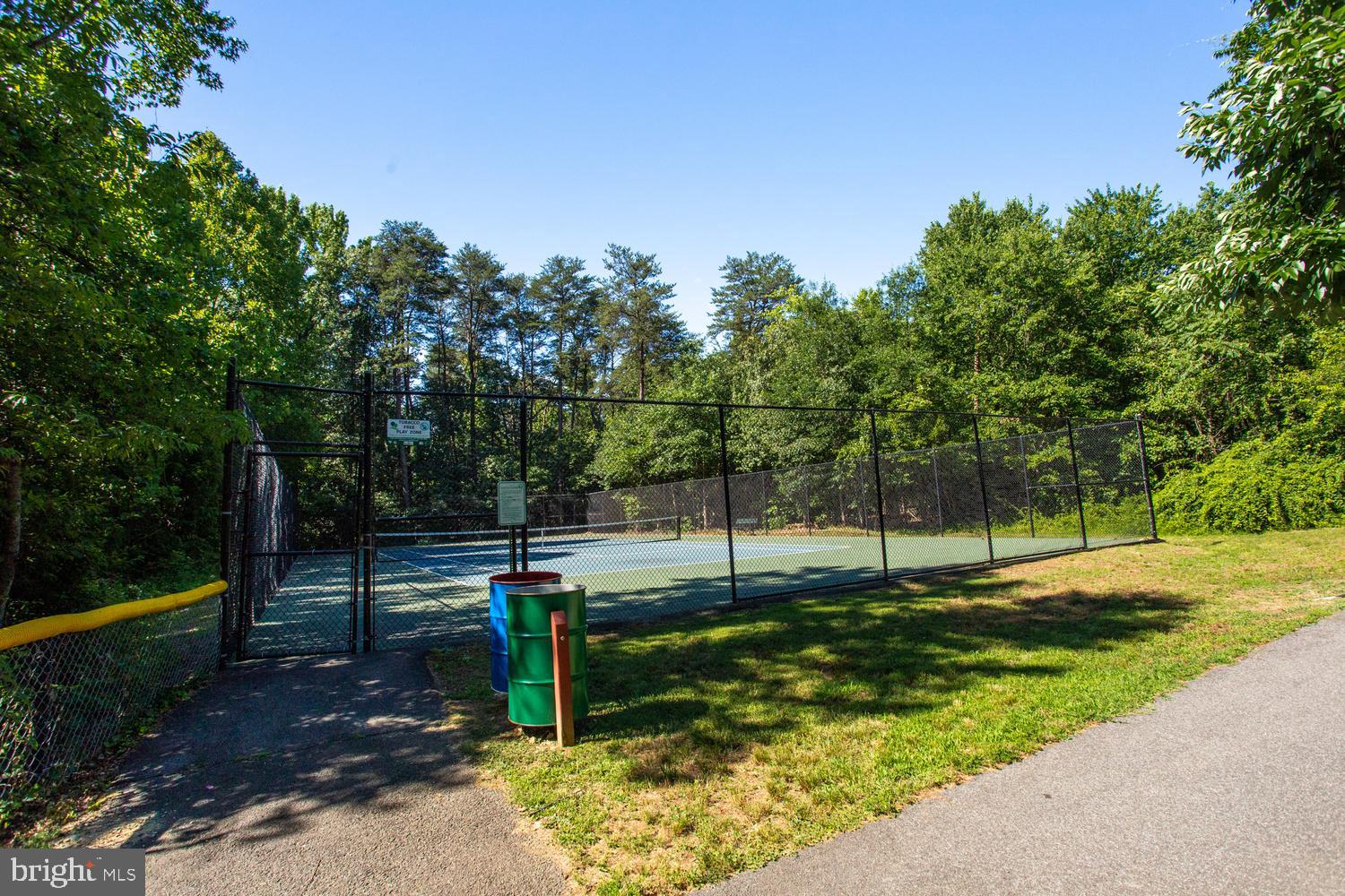 6248 Levi Court Springfield, VA 22150 - Photo 42 of 51 Serene tennis court in nature's embrace.