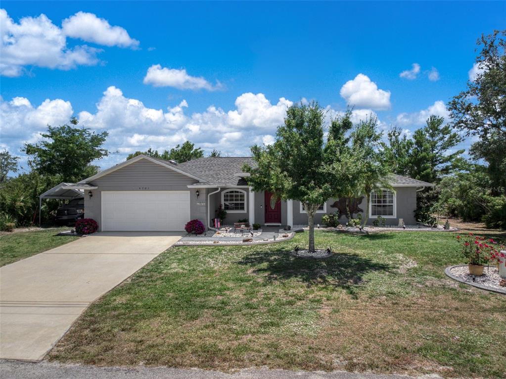 4701 Cooper Drive Sebring, FL 33872 - Photo 1 of 1 a front view of a house with a yard and garage
