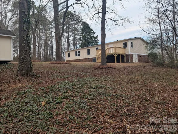 a white house that has a tree in front of it