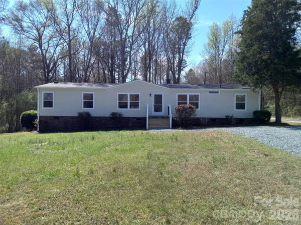 a view of a house with a backyard and a garden