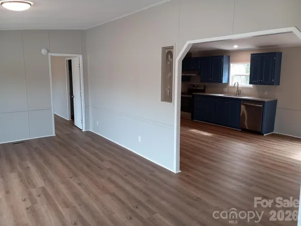 a view of kitchen with sink and refrigerator