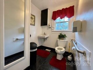 3508 Tuckaseegee Road Charlotte, NC 28208 - Photo 6 of 9 a bathroom with a toilet sink and mirror